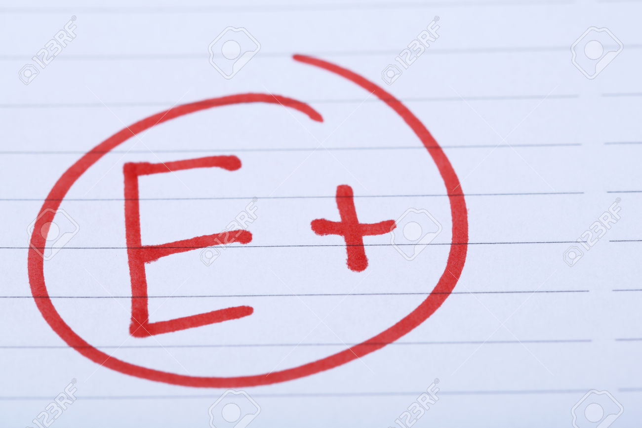 Grade E+ written on an exam paper